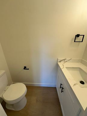 Benton City apartment for rent - A white toilet sits next to a white sink in a small bathroom.