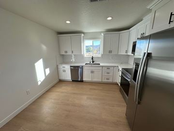 Benton City apartment for rent - A kitchen with white cabinets and stainless steel appliances.