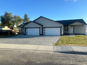 Benton City apartment for rent - A two-car garage is attached to a house.