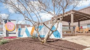 Arlington apartment for rent - A tree in front of a building with a mural on the wall.