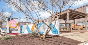 Arlington apartment for rent - A tree in front of a Zen sign and a mural.