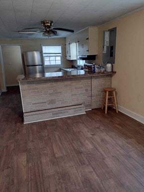 Armuchee house for rent - A kitchen with a wooden floor and a brick wall.