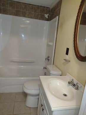 Armuchee house for rent - A white toilet sits next to a white sink in a bathroom.