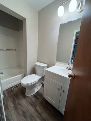 Wapakoneta house for rent - A white toilet sits in a bathroom next to a sink.