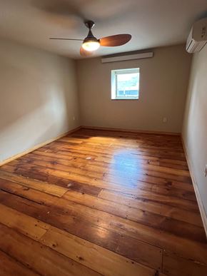 Grinnell apartment for rent - A room with wooden flooring and a ceiling fan.