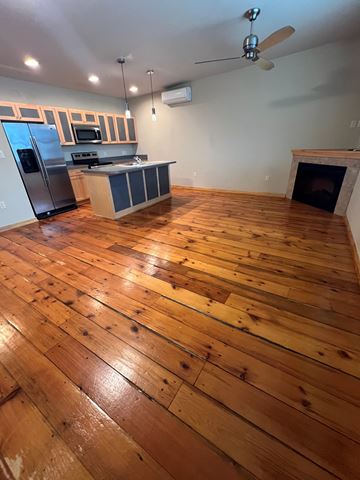 Grinnell apartment for rent - A kitchen with wooden floors and a fireplace.