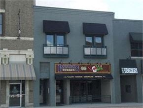 Grinnell apartment for rent - A building with a striped awning and a sign that says "Lofts".