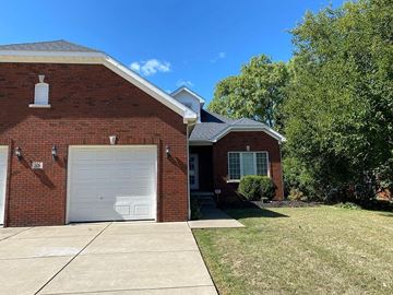 Williamsville apartment for rent - A red brick house with a white garage door.