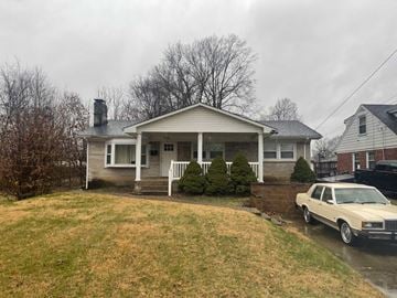 Louisville house for rent - A house with a car parked in front of it.