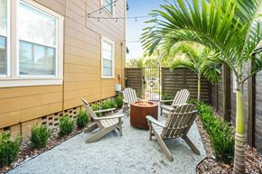 Tampa apartment for rent - A patio with a fire pit and chairs.