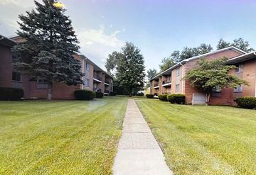 Bellevue apartment for rent - A long concrete walkway leads between two rows of apartment buildings.