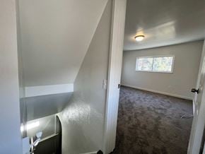 Glassport house for rent - A room with a carpeted floor and a window.