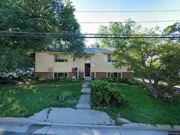 Colorado Springs apartment for rent - A house with a green lawn and a tree in front.