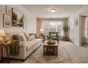 Hagerstown apartment for rent - A living room with a couch, a chair, a table, and pictures on the wall.