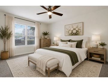 Hagerstown apartment for rent - A bedroom with a large bed and a ceiling fan.
