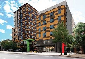 Philadelphia apartment for rent - A modern multi-story building with a combination of brown and orange hues.