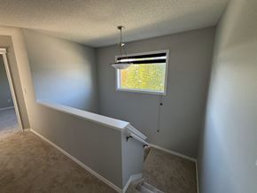 Edmonton apartment for rent - A room with a window and a light hanging from the ceiling.