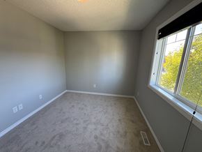 Edmonton apartment for rent - A room with a carpeted floor and a window.