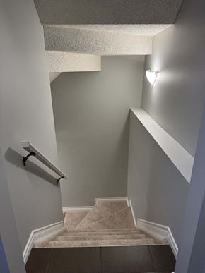 Edmonton apartment for rent - A staircase with a light on the wall.