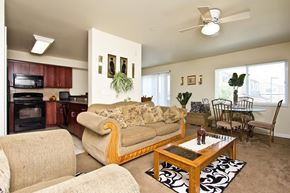 Longmont townhouse for rent - A living room with a couch, chairs, and a coffee table.