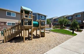 Longmont townhouse for rent - A playground in a residential area with a wooden slide and a green roof.