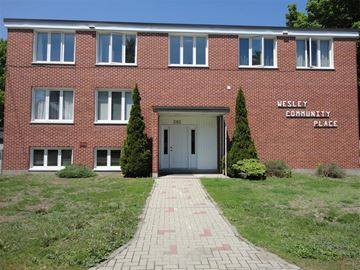Pembroke apartment for rent - A brick building with a sign that says Wesley Community Place.