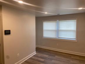 Washington apartment for rent - A room with a window covered by white blinds.