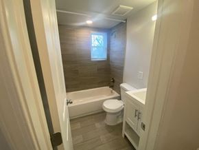 Washington apartment for rent - A bathroom with a toilet, sink, and bathtub.