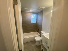 Washington apartment for rent - A bathroom with a toilet, sink, and bathtub.