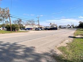 Sweeny house for rent - A street view with a building on the right and cars parked on the side of the road.