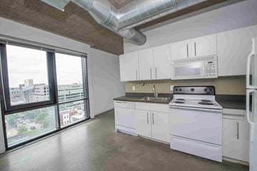 Philadelphia apartment for rent - A kitchen with white cabinets and a stove top oven.