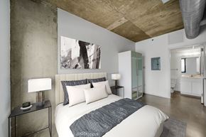 Philadelphia apartment for rent - A bedroom with a large bed and a painting on the wall.