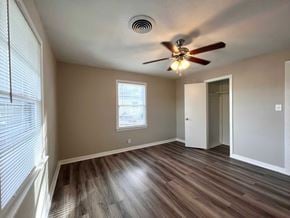 Bay City house for rent - A room with a ceiling fan and a window with blinds.