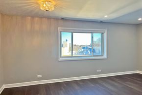 Forest Park apartment for rent - A room with a large window and a wooden floor.