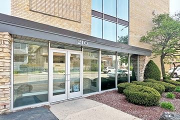 Forest Park apartment for rent - The image shows the front of a building with the number 210 on it.