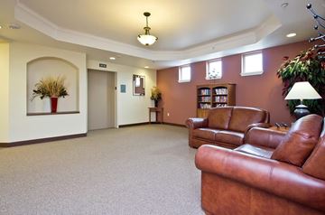 Longmont apartment for rent - A living room with brown leather couches and a carpeted floor.