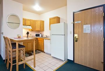 Longmont apartment for rent - A kitchen with a table and chairs and a fridge.
