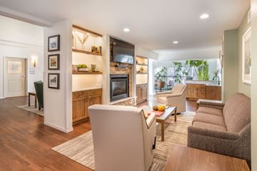 Longmont apartment for rent - A modern living room with a grey sofa and a white refrigerator.