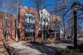 Longmont apartment for rent - A street view of a building with a black lamp post in front.