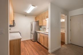 Longmont apartment for rent - A kitchen with wooden cabinets and a refrigerator.