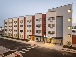 Longmont apartment for rent - A modern building with a row of windows and a sign that says "Vina".