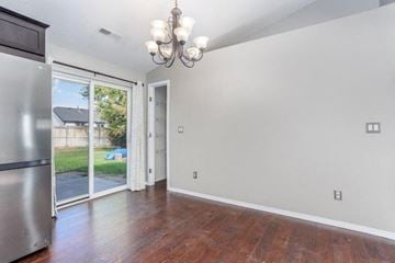 Pasco house for rent - A kitchen with a refrigerator and a chandelier.