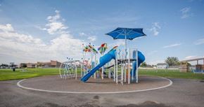 Pasco house for rent - A playground with a blue umbrella and a blue slide.