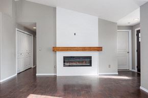Pasco house for rent - A modern living room with a fireplace and wood flooring.