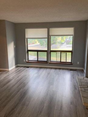 Richland house for rent - A room with a large window and wooden flooring.