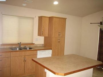 Richland house for rent - A kitchen with wooden cabinets and a countertop.