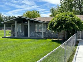 Pasco apartment for rent - A house with a grey roof and a fence.