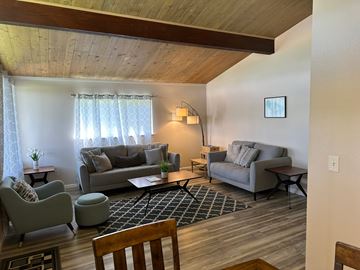 Pasco apartment for rent - A living room with a grey couch and a wooden table.