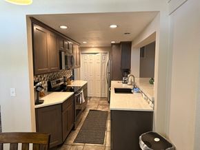 Pasco apartment for rent - A kitchen with brown cabinets and a white countertop.