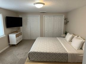 Pasco apartment for rent - A bedroom with a bed, dresser, and television.